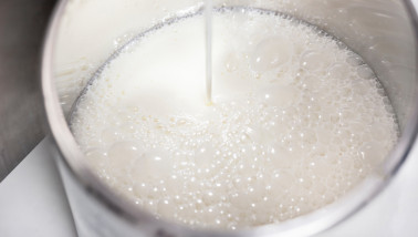 Pouring fresh milk into a glass, dairy product ready to drink